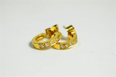 Lot 25 - A pair of 18 carat gold and diamond earrings, with post fittings for pierced ears (2)