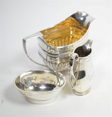 Lot 51 - A late George III silver cream jug, crested; and an 18th century style silver morning cream and...