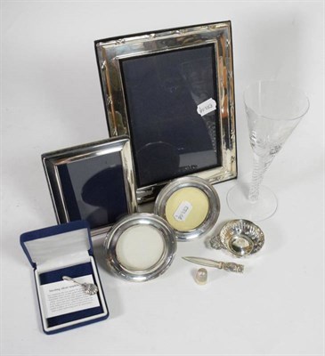 Lot 58 - Four silver frames; a French silver plate wine taster; a silver owl form bookmark; a silver...