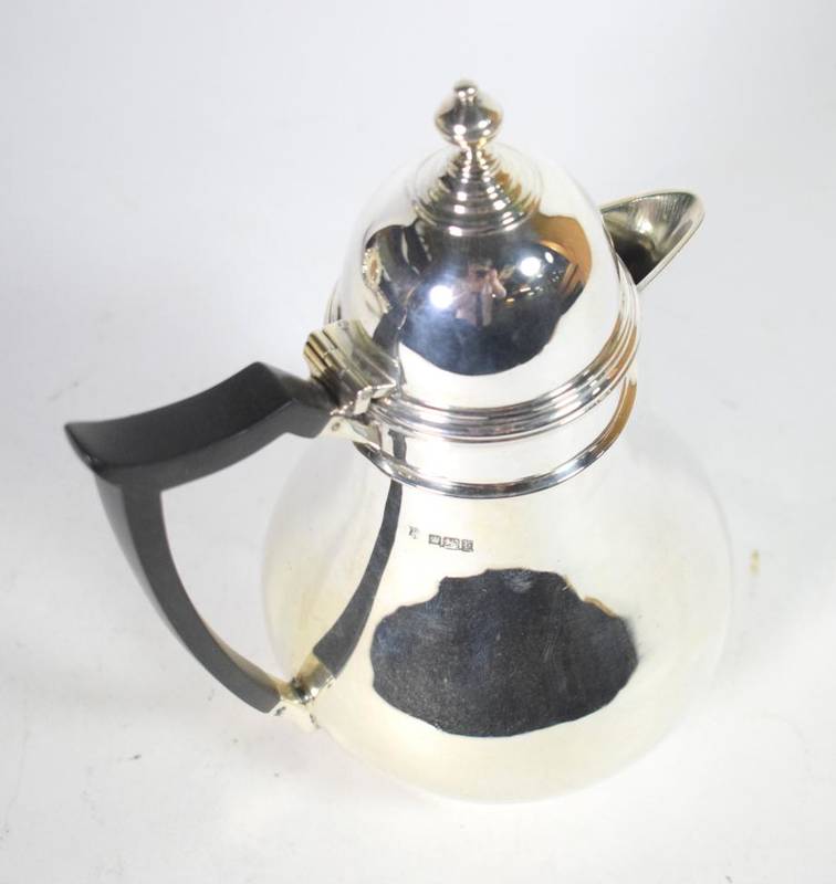 Lot 68 - An Edwardian silver hot water jug, Thomas Bradbury & Sons, Sheffield 1909, baluster with domed...