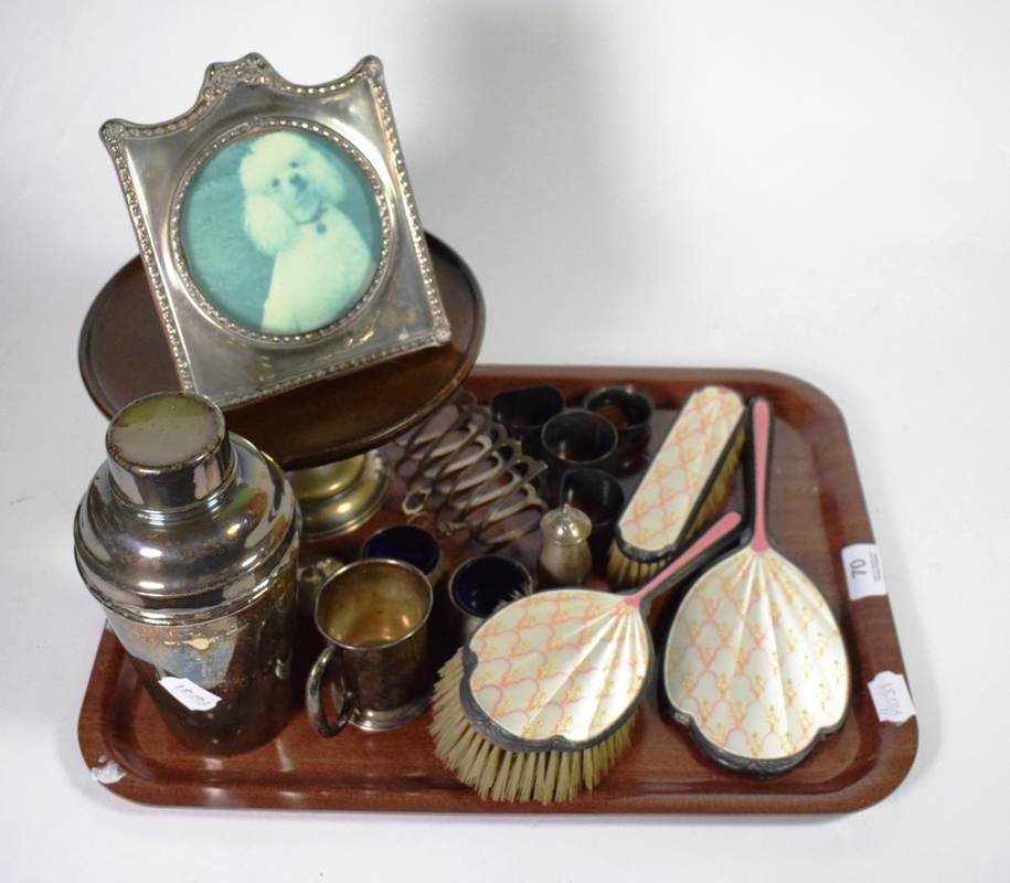 Lot 70 - Assorted silver to include a photograph frame; an enamel part dressing table set; a toastrack...