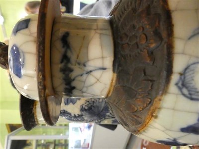 Lot 71 - A garniture of three Chinese blue and white porcelain vases, decorated with dragons