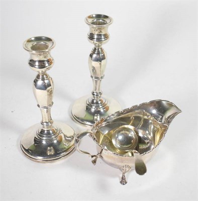 Lot 72 - A pair of silver candlesticks, Adie Bros, Birmingham 1926, loaded; together with a silver sauce...