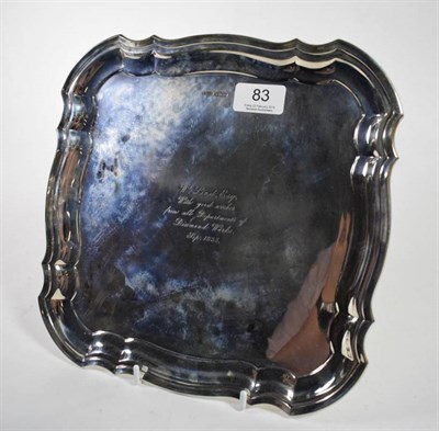 Lot 83 - A shaped square silver salver, Harrison Fisher & Co, Sheffiled 1934, on four scroll feet,...