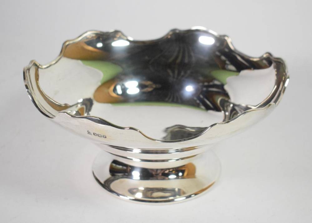 Lot 85 - A silver pedestal bowl, James Deakin & Sons, Sheffield 1932, circular with shaped rim, presentation