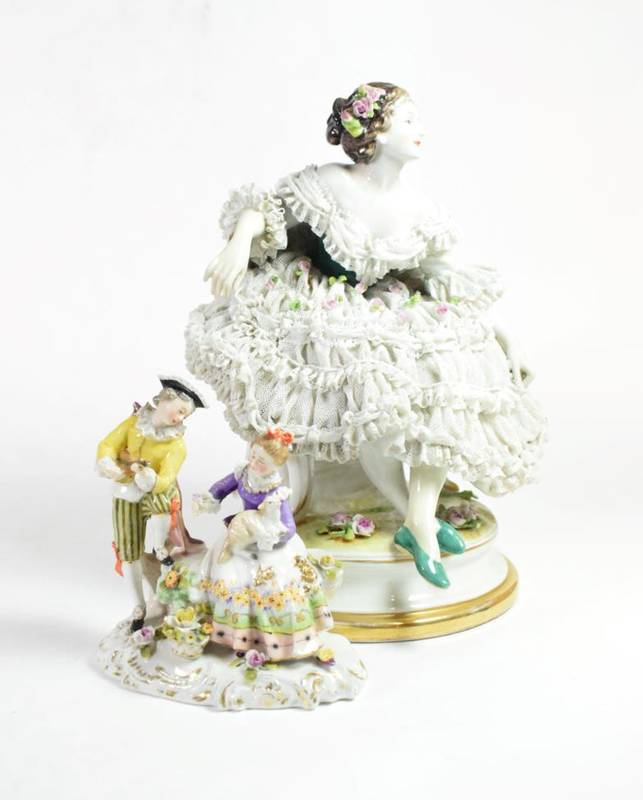 Lot 86 - A Vienna porcelain figure group; together with an Augustus Rex figure of a seated lady in a...