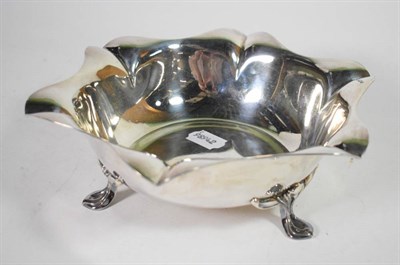 Lot 109 - An Art Nouveau silver dish, H Pidduck & Sons, Sheffield 1916, shaped rim, on three stylised...