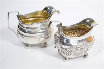 Lot 113 - A George III silver cream jug, London 1798, later chased; and another example, London 1807, the...