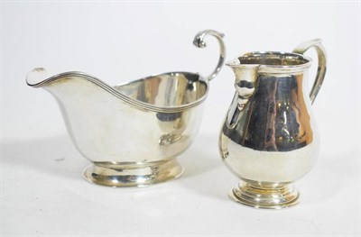 Lot 126 - A silver sparrow beak cream jug, London 1917, in the 18th century style; and a silver sauce...