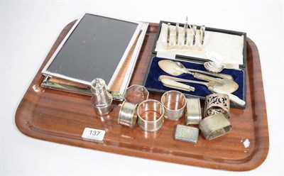 Lot 137 - A group of assorted silver items to include: two photograph frames; various napkin rings; a...