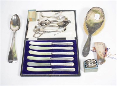 Lot 139 - A quantity of silver to include assorted spoons; napkin rings; silver handled knives; and a...