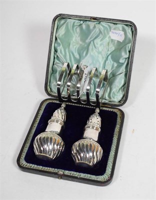 Lot 157 - A pair of Victorian silver pepper pots, Walker & Hall, Sheffield 1893, part spirally fluted and...