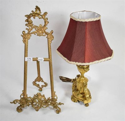 Lot 175 - A gilt metal table lamp of urn form decorated with swags together with a reproduction scrolling...