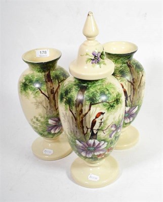 Lot 178 - A Victorian painted opaque glass garniture comprising a pair of vases and a jar and cover,...