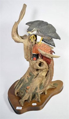 Lot 190 - A large composition model of a Peregrine Falcon, with a pheasant in it's talons, perched upon a...