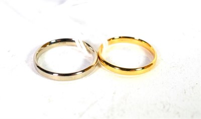 Lot 227 - An 18 carat gold band ring, finger size M; and an 18 carat white gold band ring, finger size N (2)