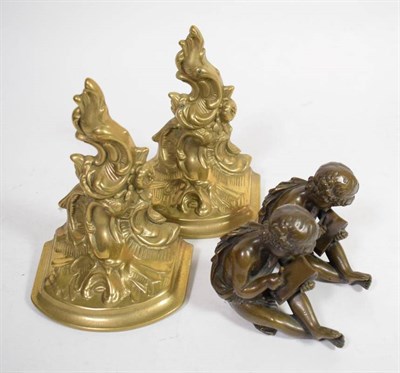 Lot 276 - A pair of bronze seated cherubs, modelled writing with stylus on tablet, together with a pair...