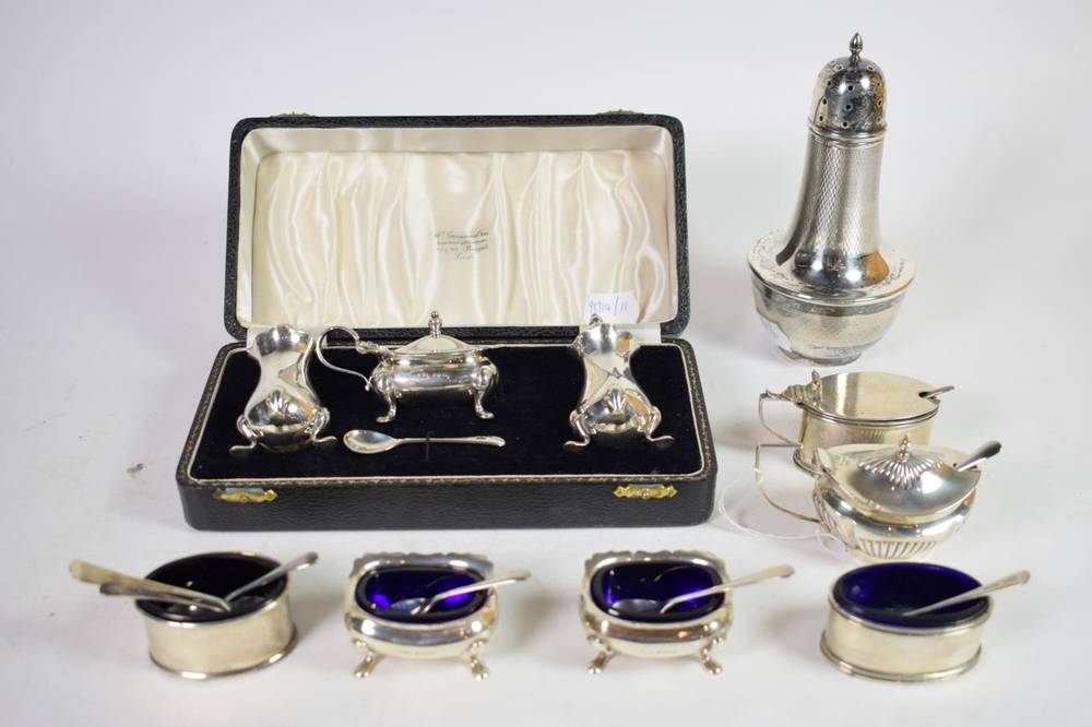 Lot 326 - Three various 20th century silver three piece condiment sets, one cased, and a silver clad...