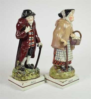 Lot 341 - A pair of early 19th century pearlware figures, circa 1820, of a man and woman, both titled ''Age''