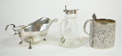 Lot 343 - A Georgian style silver sauceboat, Sheffield, 1932; a silver topped glass whisky noggin,...