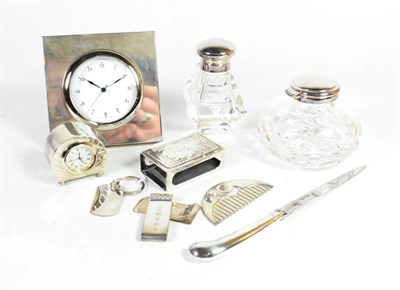 Lot 352 - Mixed silver items comprising: two silver mounted bedside timepieces, the largest timepiece...
