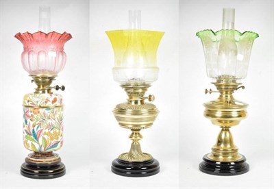 Lot 362 - Three oil lamps, with coloured glass shades