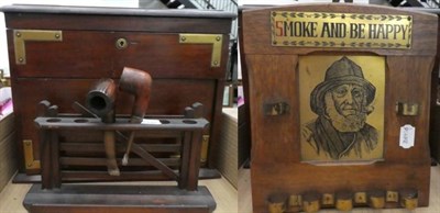 Lot 1005 - A collection of smoking paraphenalia including smoker's cabinet; pipe racks; and a German...