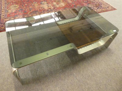 Lot 1154 - A mid 20th century modern coffee table with silvered metal base, glass top and a slung shelf