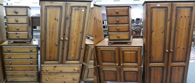 Lot 1166 - A six piece pine bedroom suite comprising: two wardrobes; a pair of bedside chests of drawers;...