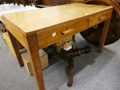 Lot 1183 - A pine farmhouse table fitted with a drawer and later formica top; a two drawer pine desk with...