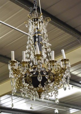 Lot 1195 - A French crystal, gilt and black painted bronze twelve light chandelier