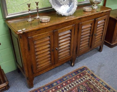 Lot 1197 - A 19th century Continental walnut sideboard with four grill cupboard doors