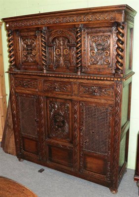 Lot 1204 - A reproduction oak carved court cupboard