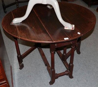 Lot 1221 - An early 18th century drop-leaf table with turned legs and splayed feet