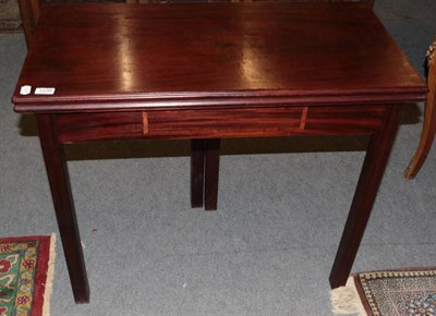 Lot 1236 - George III style mahogany fold over tea table, on square chamfered legs