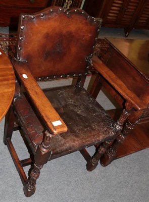 Lot 1243 - Pair of carved oak and close-nailed leather armchairs