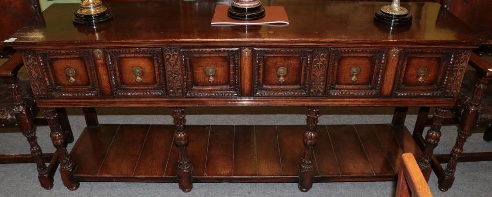 Lot 1244 - G T Rackstraw oak sideboard in 17th century style, with three drawers and carved legs, joined...