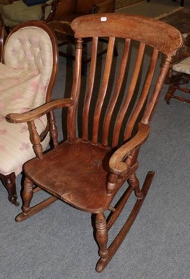 Lot 1251 - A 19th century elm seated rocking chair