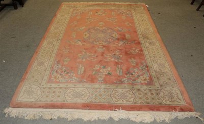 Lot 1265 - Chinese Carpet, the coral pink field of Taoist motifs around a medallion framed by lattice borders