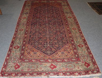 Lot 1267 - Malayir Rug, West Iran, the indigo Herati field enclosed by ivory borders, 300cm by 158cm