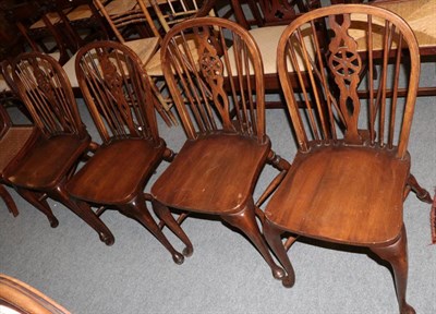 Lot 1271 - A set of four Windsor chairs by Thomas Glenister Co., High Wycombe, with crinoline stretcher...