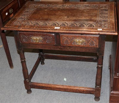 Lot 1279 - An 18th century carved oak two-drawer side table