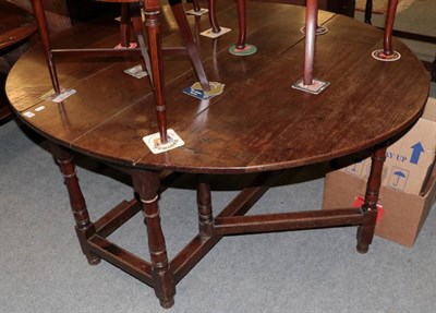 Lot 1289 - George III oak drop-leaf dining table