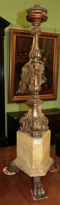 Lot 1297 - Carved giltwood candle stand on three claw feet