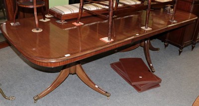 Lot 1298 - Mahogany crossbanded twin-pedestal dining table in the Regency style, with one additional leaf