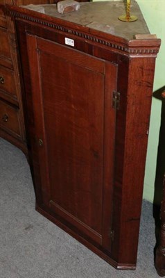 Lot 1314 - A George III oak hanging corner cupboard