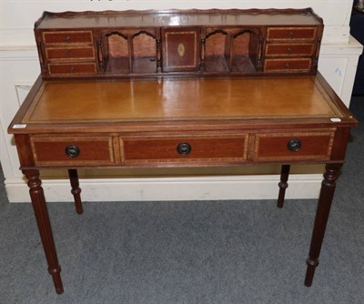 Lot 1327 - A reproduction leather inset crossbanded mahogany writing table, the superstructure fitted with...