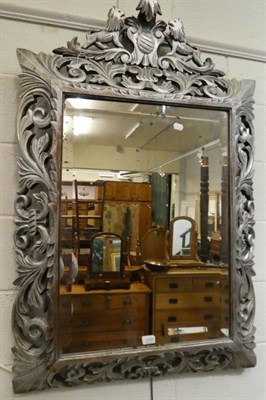 Lot 1330 - A 19th century foliate carved bevel glass mirror with silver painted frame