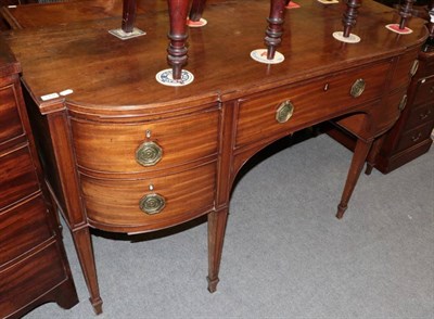 Lot 1332 - A George III mahogany breakfront sideboard, early 19th century, with central frieze drawer above an