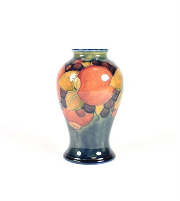 Lot 222 - William Moorcroft (1872-1945): A Pomegranate Pattern Baluster Vase, on a blue ground, impressed...